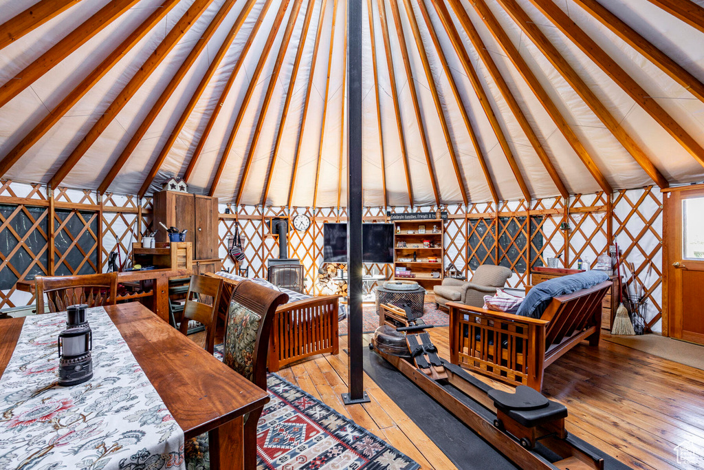 Office space featuring hardwood / wood-style floors and a wood stove