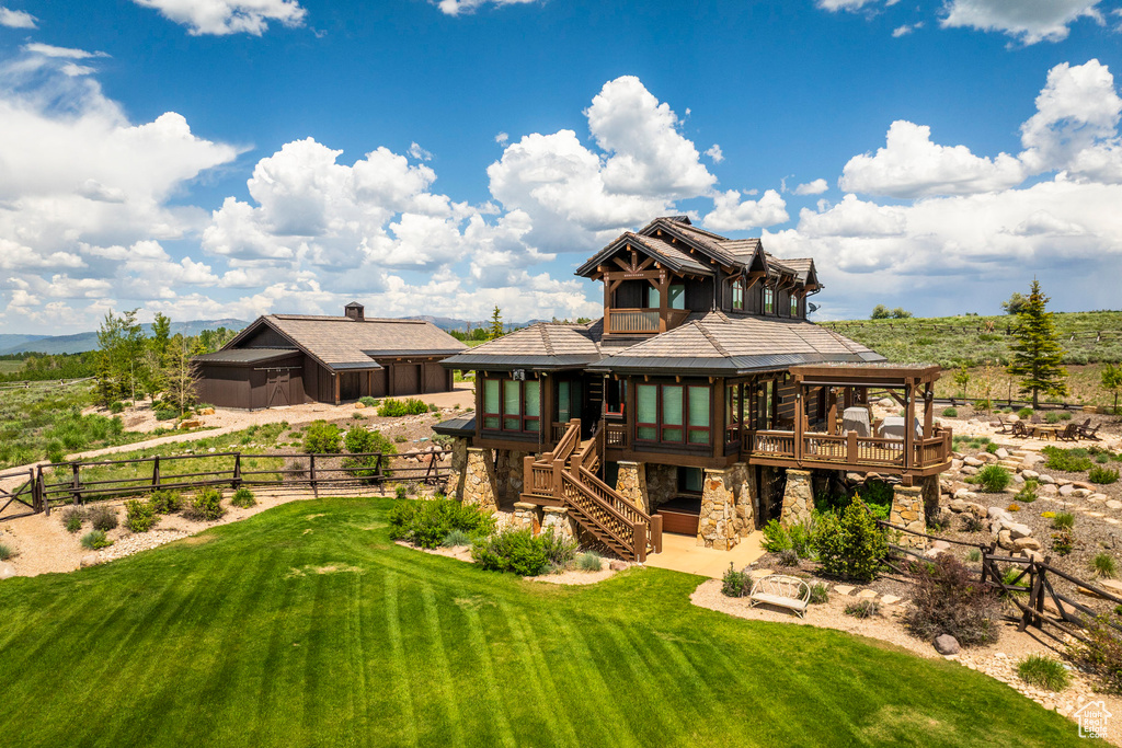 Back of house featuring a fenced backyard, a patio, a sunroom, stairs, and a wooden deck
