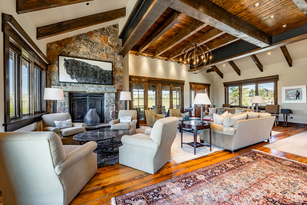 Living area featuring hardwood / wood-style floors, a fireplace, a chandelier, and recessed lighting