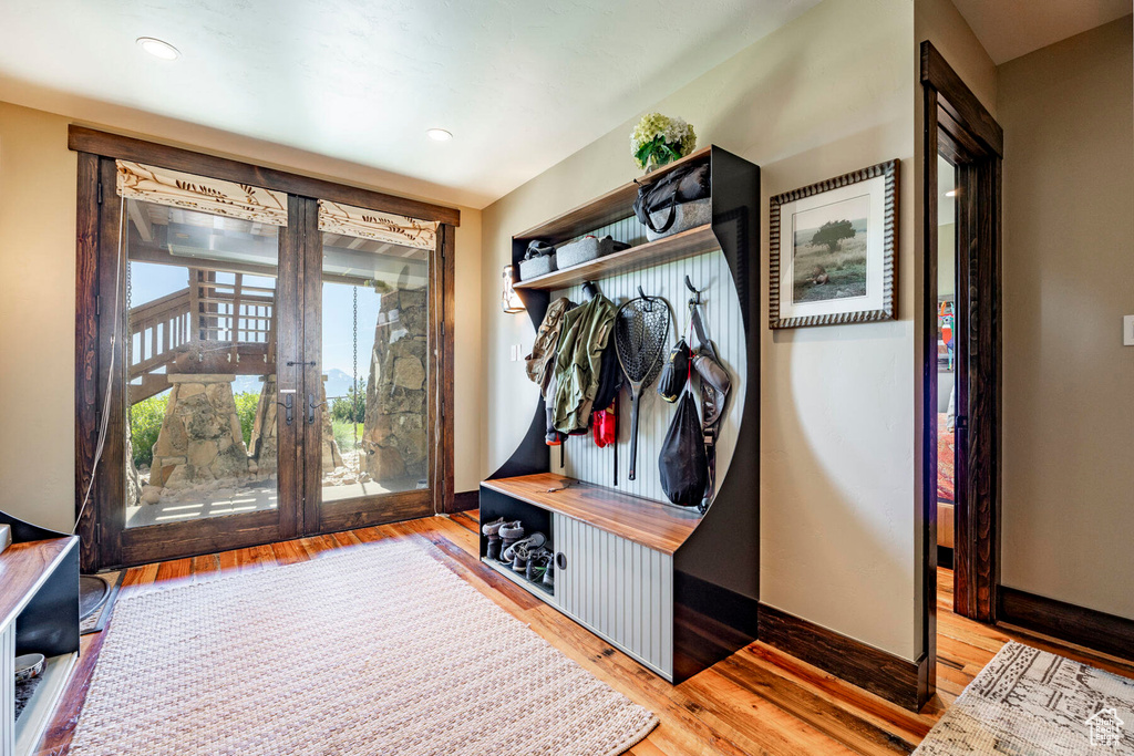 Mudroom with wood finished floors and recessed lighting