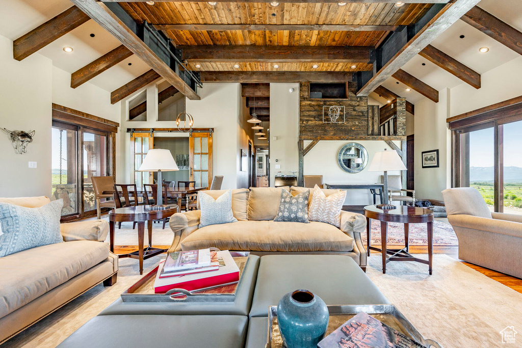 Living room with wood finished floors, recessed lighting, a wooden ceiling with exposed beams, and high vaulted ceiling