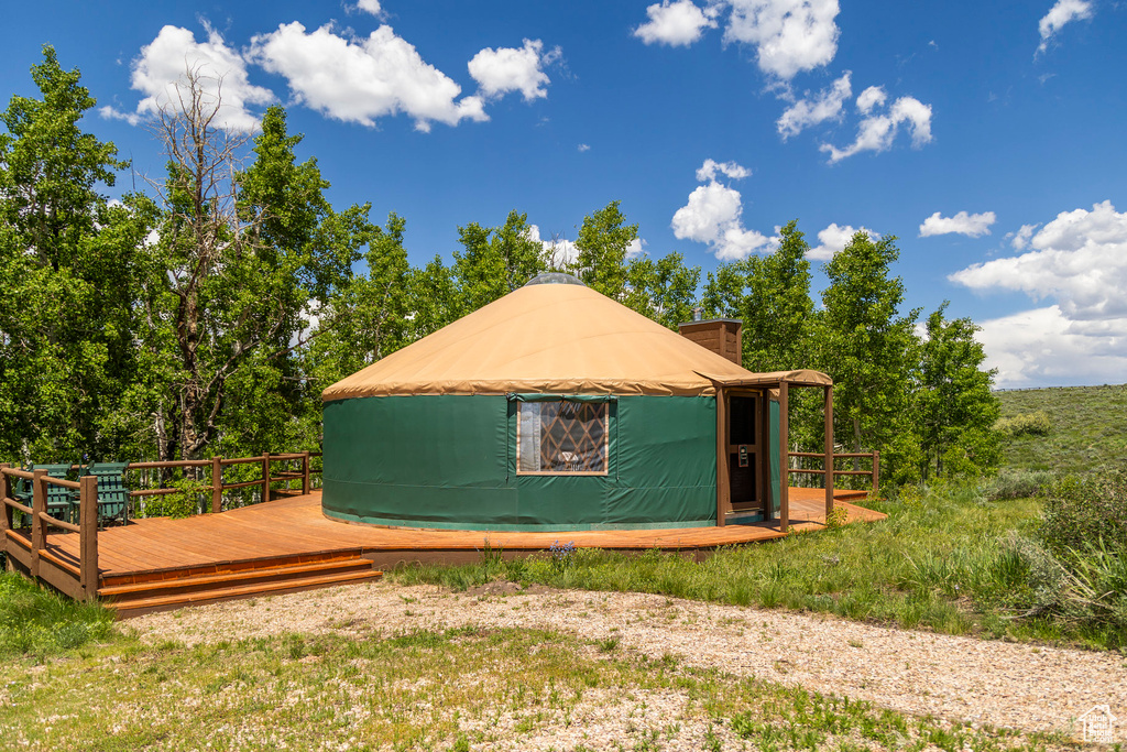 View of property exterior with a wooden deck