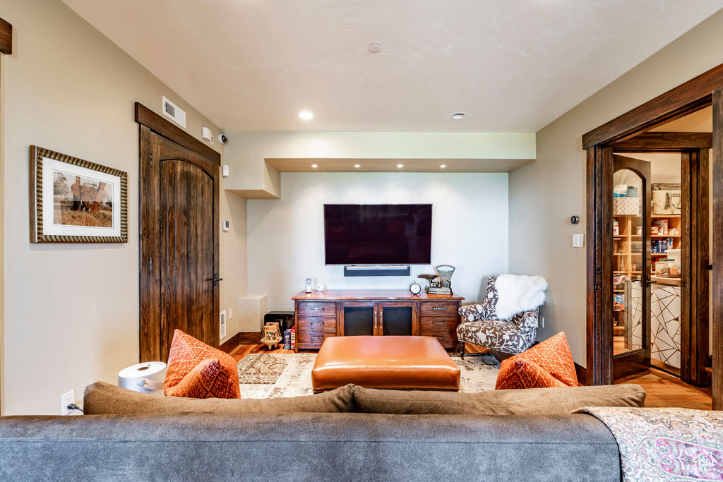 Living room with wood finished floors and recessed lighting