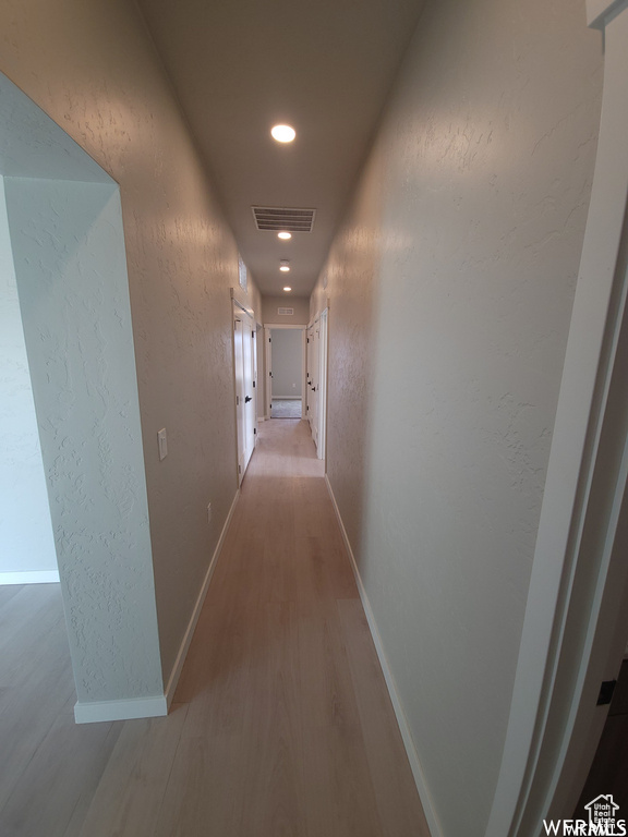 Corridor featuring wood-type flooring