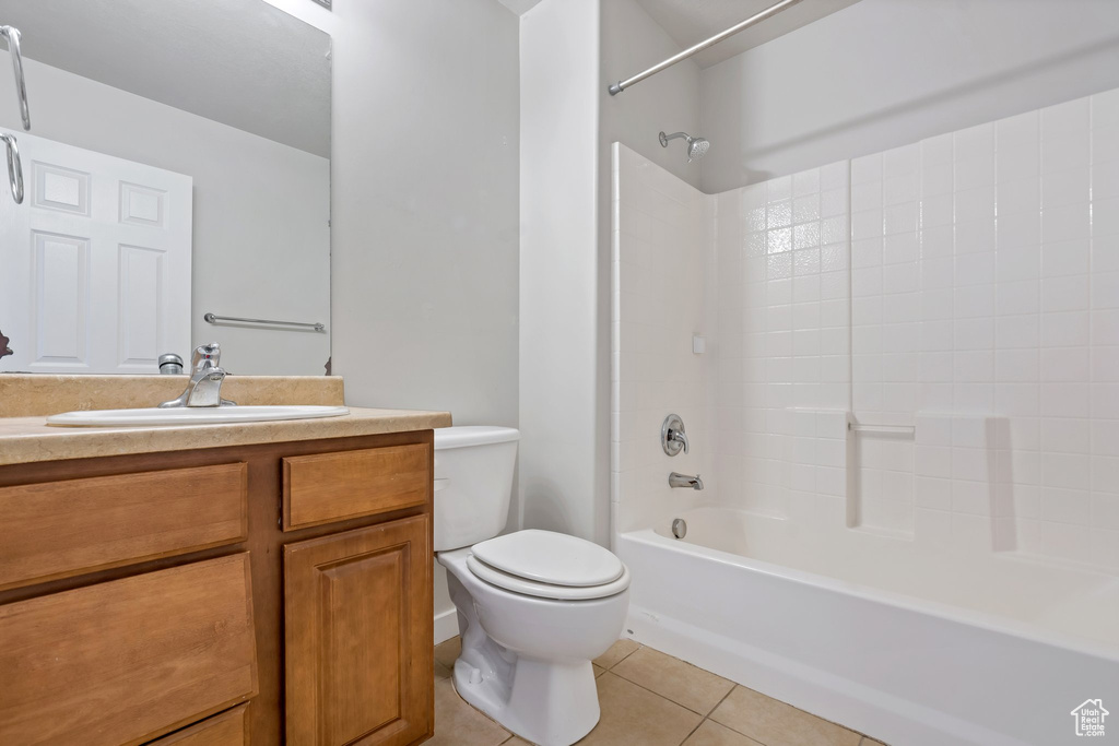 Full bathroom with shower / bathing tub combination, vanity, toilet, and tile floors