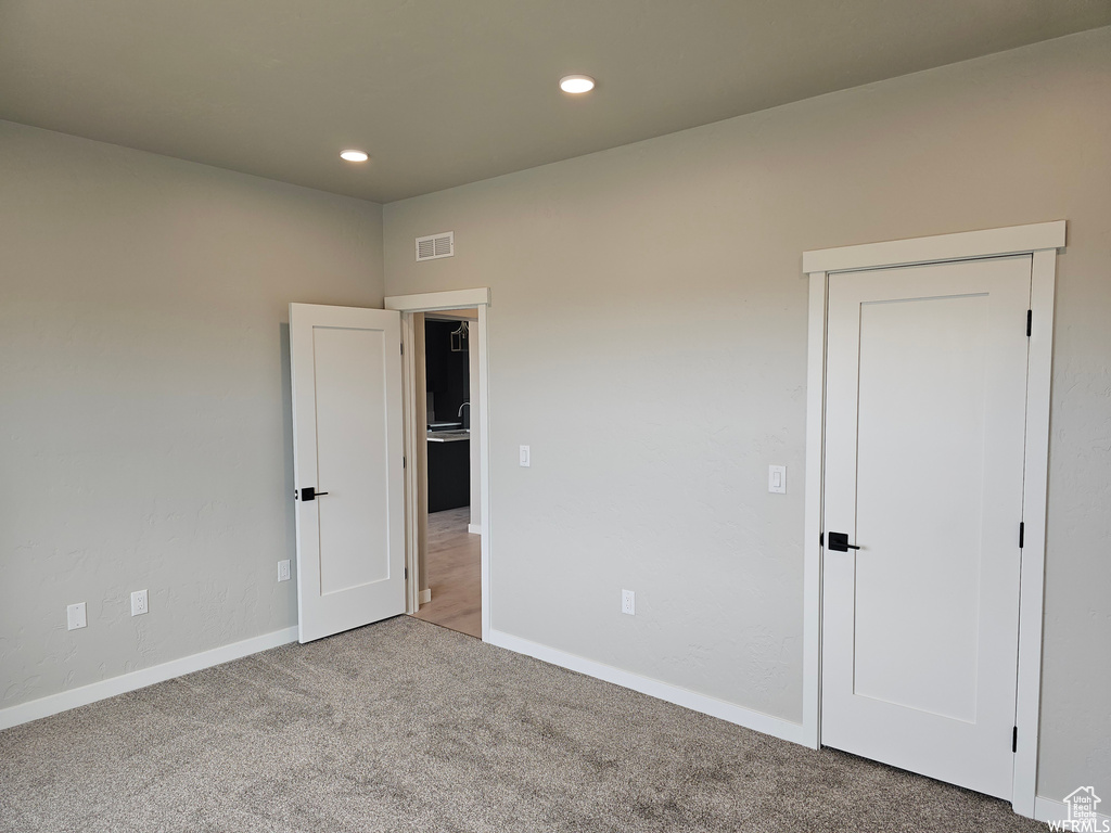 Empty room with carpet floors