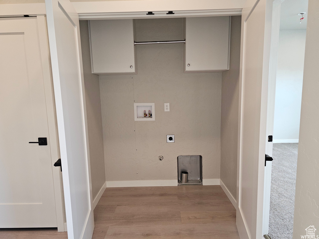 Washroom featuring hookup for a gas dryer, hookup for a washing machine, electric dryer hookup, and hardwood / wood-style floors