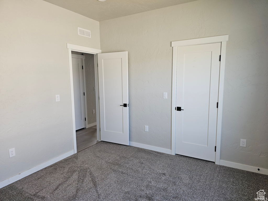 Unfurnished bedroom with carpet