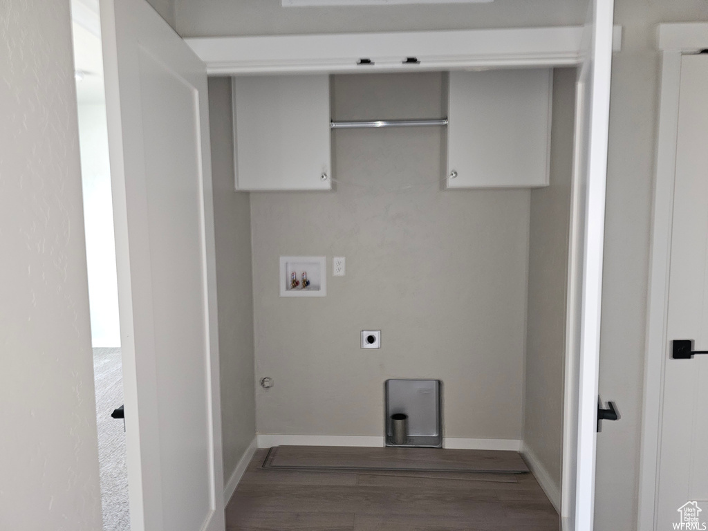 Laundry area featuring hookup for a washing machine, hardwood / wood-style floors, hookup for an electric dryer, and hookup for a gas dryer