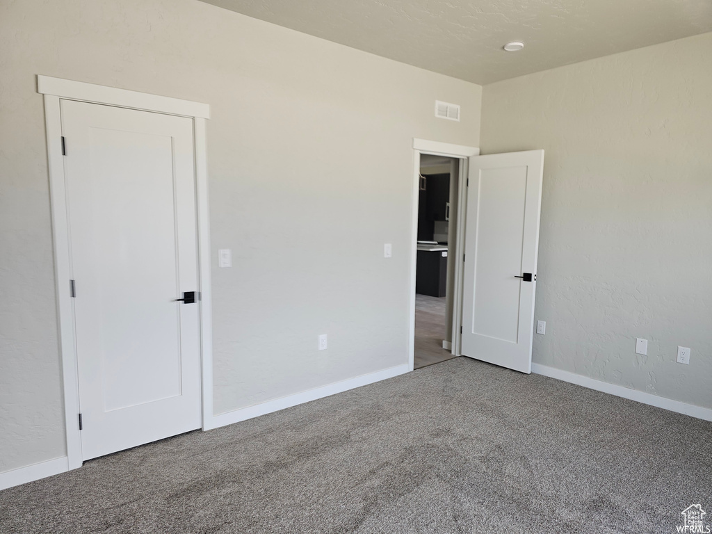 Spare room featuring carpet flooring