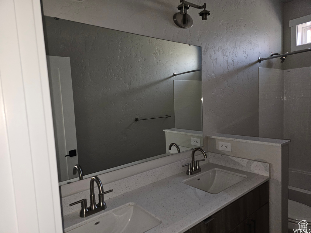 Bathroom featuring double sink and large vanity