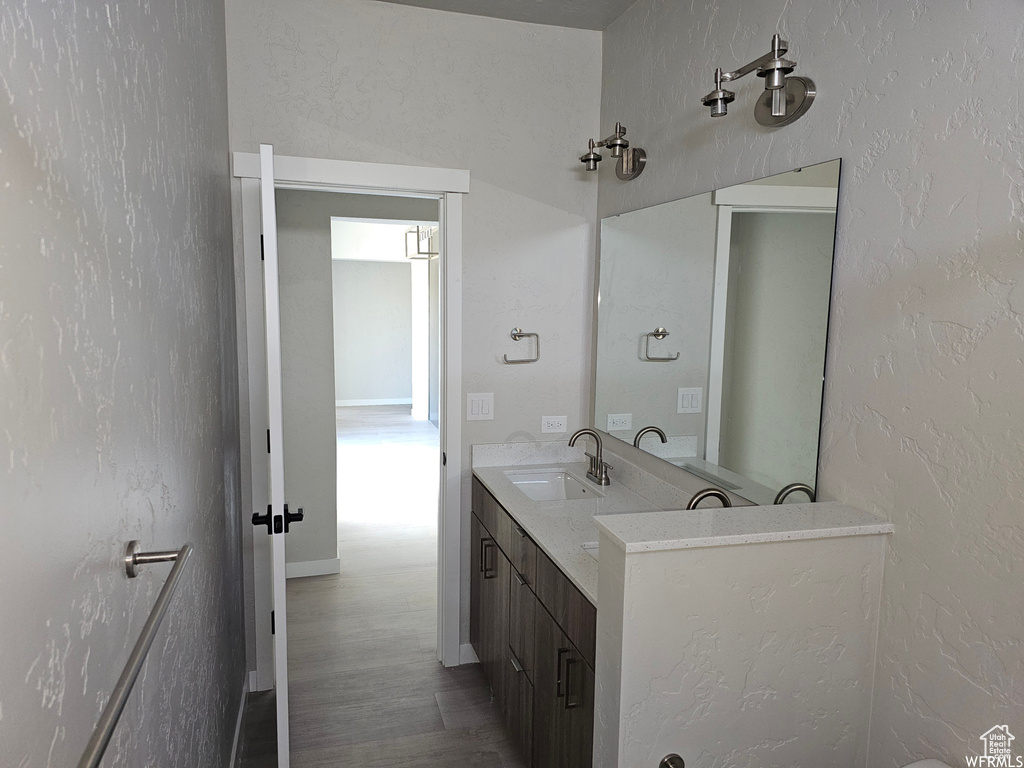 Bathroom featuring double vanity and hardwood / wood-style flooring