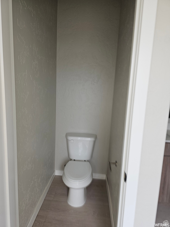 Bathroom featuring hardwood / wood-style floors and toilet