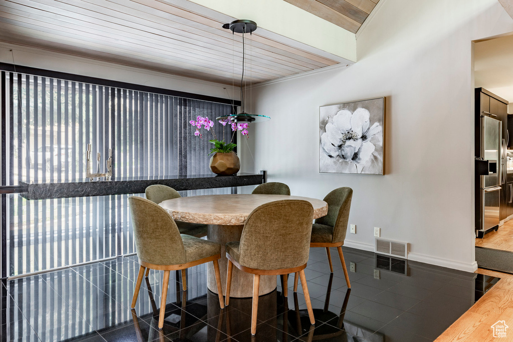 Tiled dining room with wood ceiling