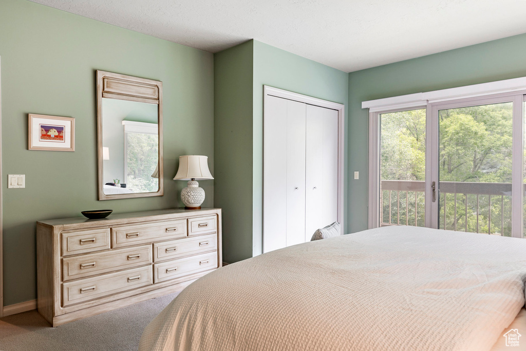 Bedroom featuring access to outside, a closet, and carpet floors