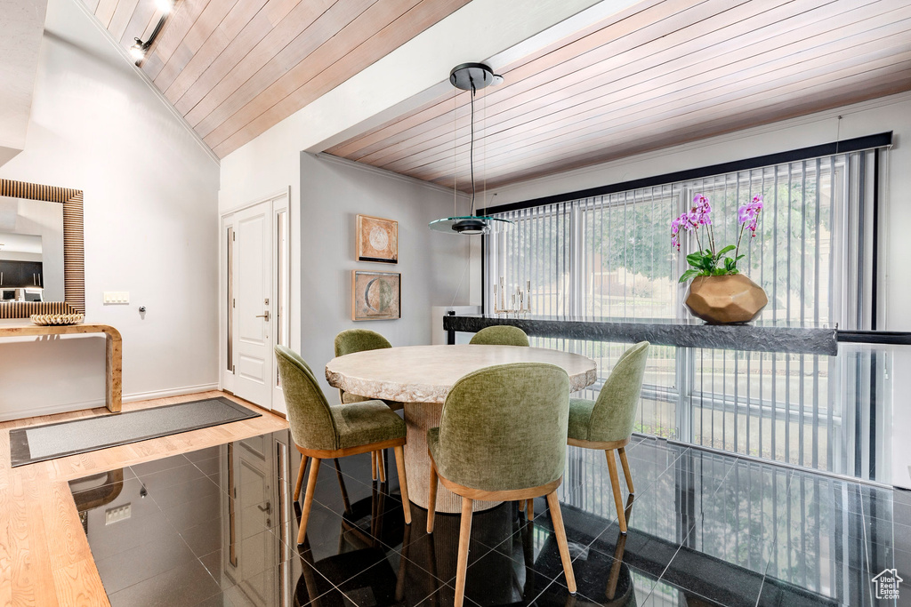 Tiled dining room with plenty of natural light, lofted ceiling, and wood ceiling