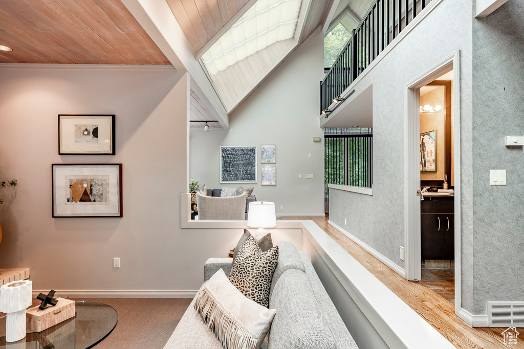 Living room with light hardwood / wood-style flooring and wood ceiling