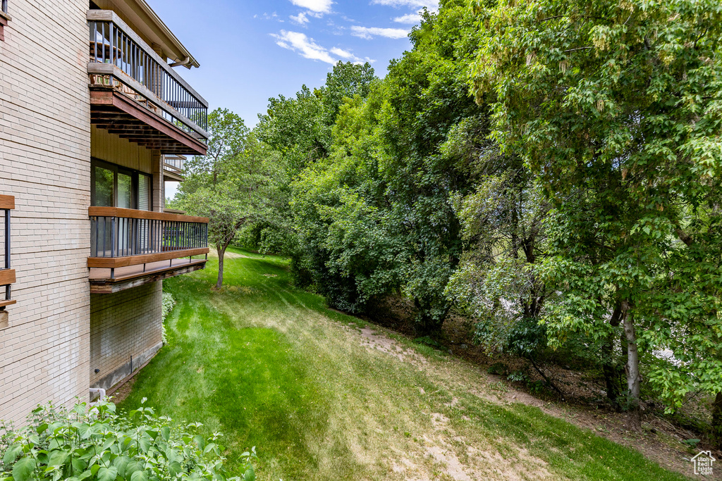 View of yard featuring a balcony