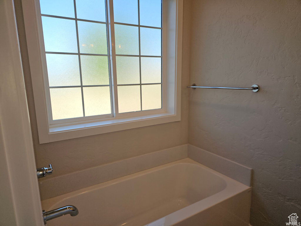 Bathroom with a wealth of natural light and a bath to relax in