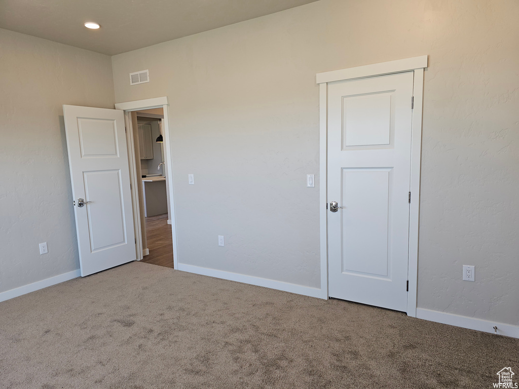 Unfurnished bedroom featuring carpet