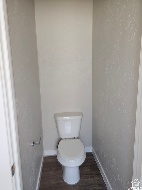 Bathroom featuring wood-type flooring and toilet