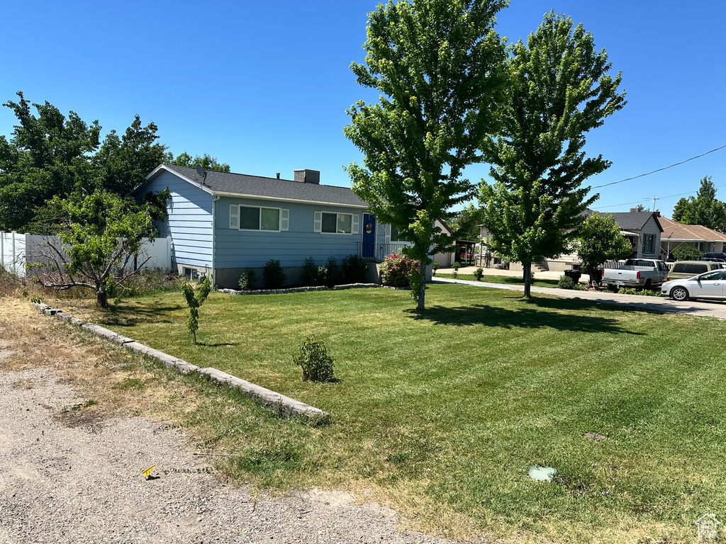 Single story home featuring a front lawn