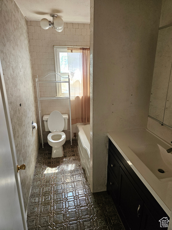 Full bathroom with tile floors, vanity, toilet, and shower / bathing tub combination