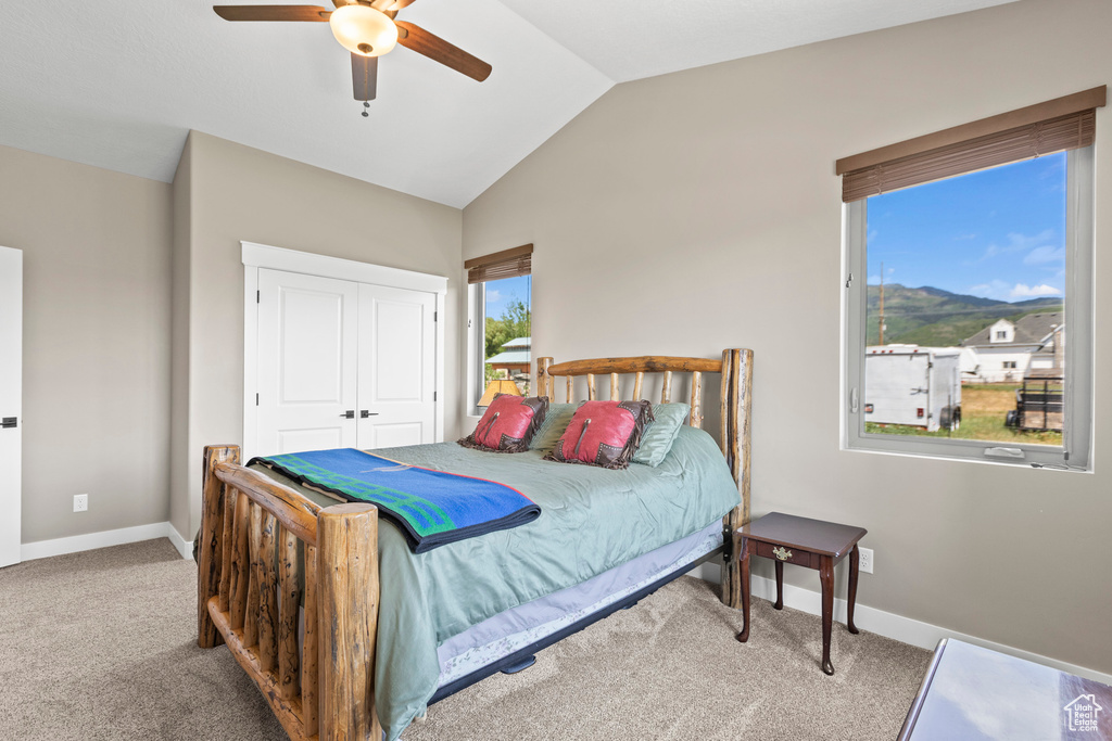 Bedroom featuring carpet, a closet, ceiling fan, and lofted ceiling