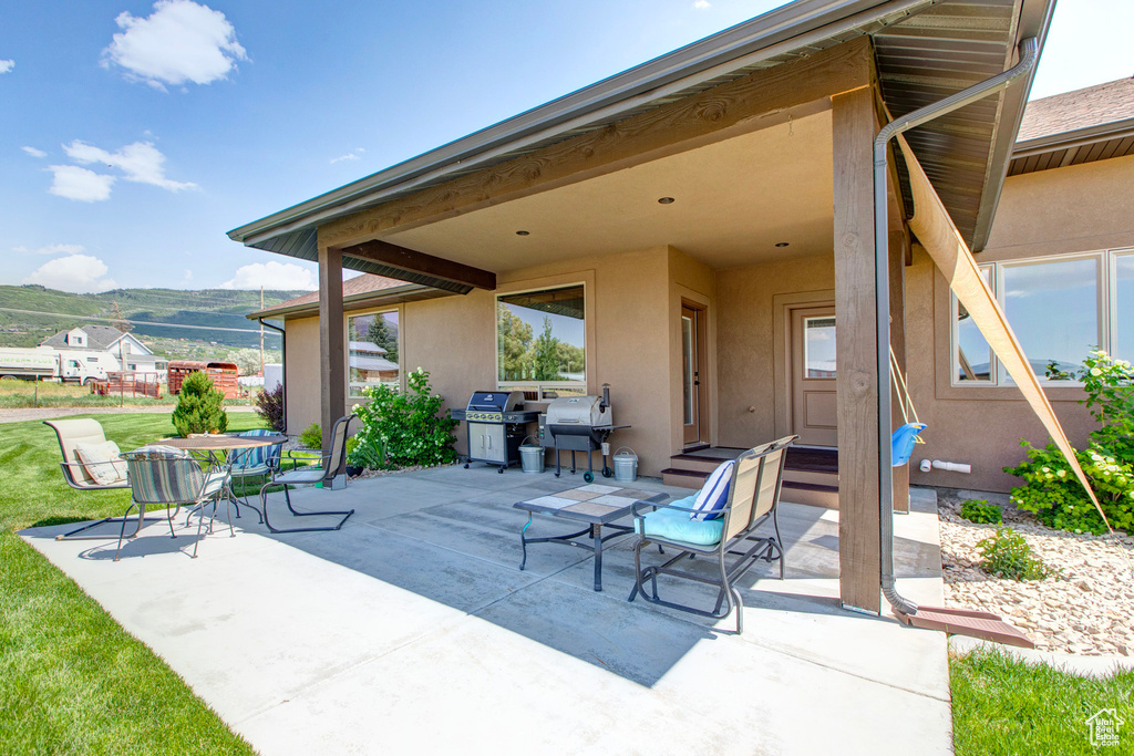 View of patio / terrace featuring grilling area and a mountain view