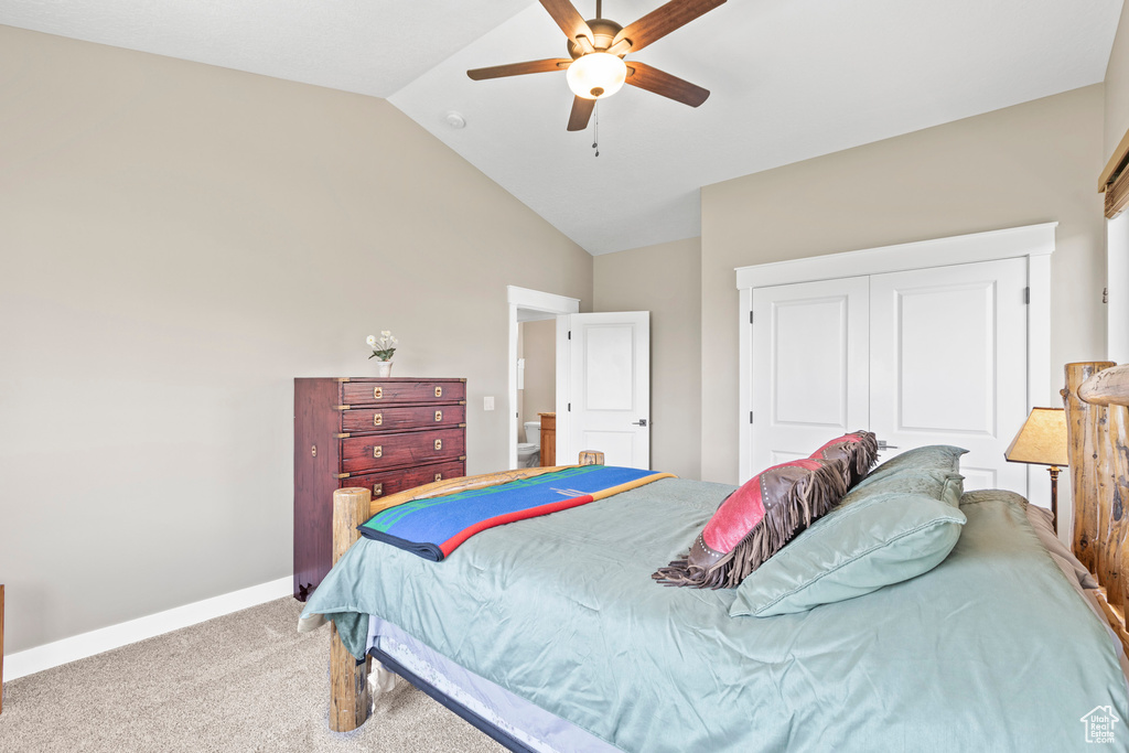 Bedroom featuring carpet flooring, high vaulted ceiling, a closet, and ceiling fan