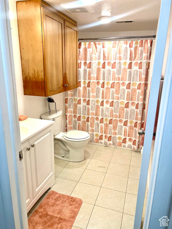 Bathroom with tile floors, toilet, and vanity