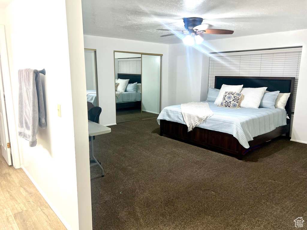 Bedroom featuring ceiling fan and hardwood / wood-style flooring