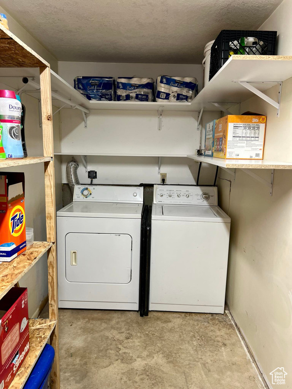 Clothes washing area with a textured ceiling and washing machine and clothes dryer