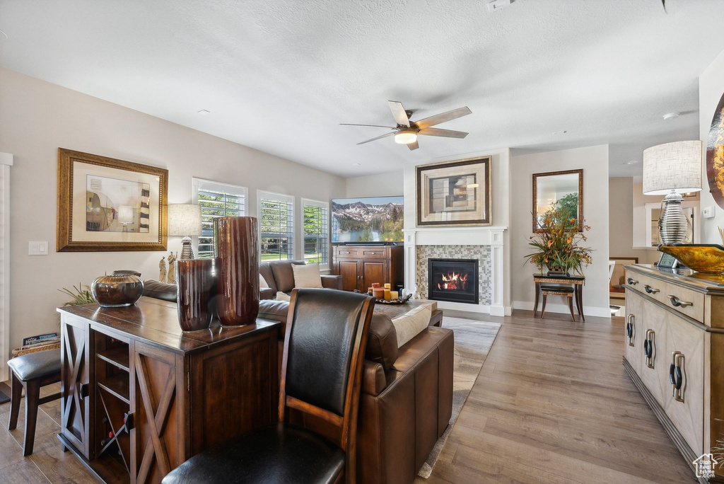 Living room with light hardwood / wood-style floors and ceiling fan