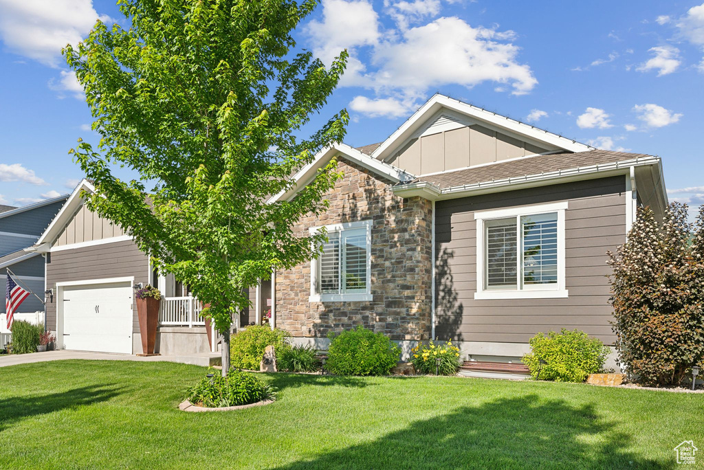 Craftsman-style home with a front yard and a garage