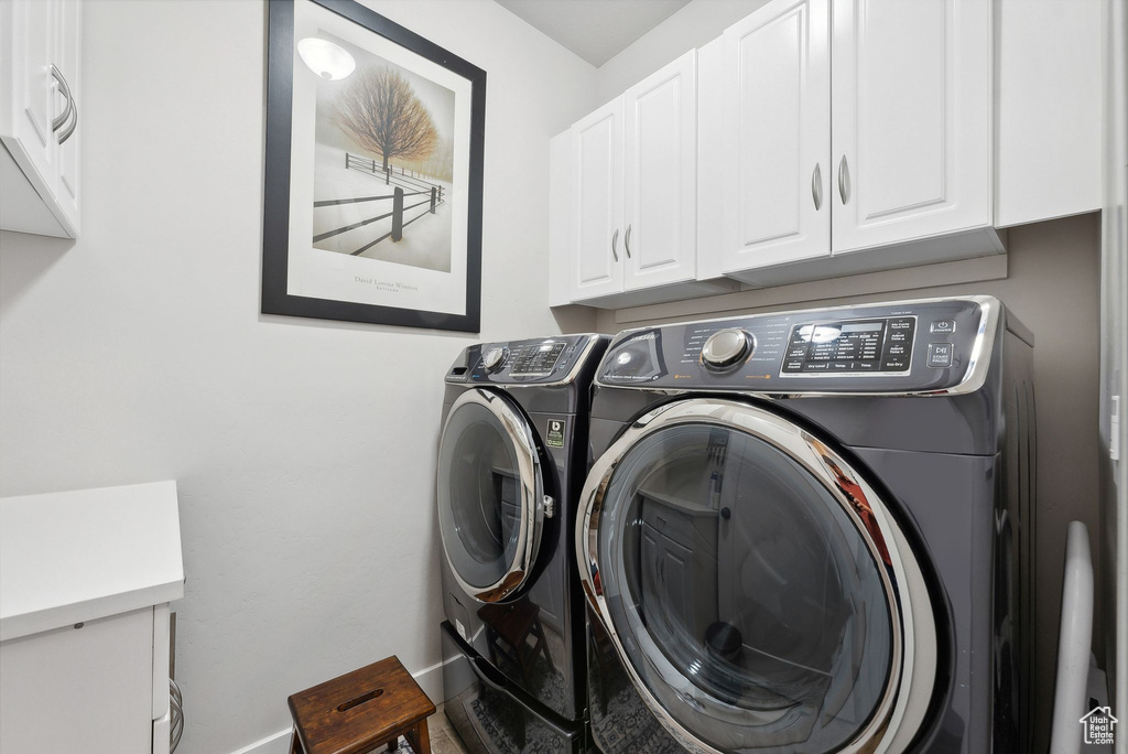 Clothes washing area with cabinets and washing machine and dryer