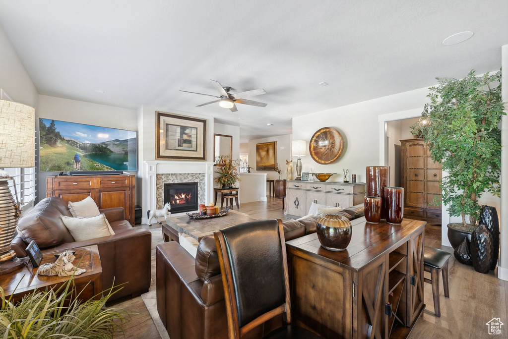 Living room featuring ceiling fan and light hardwood / wood-style flooring