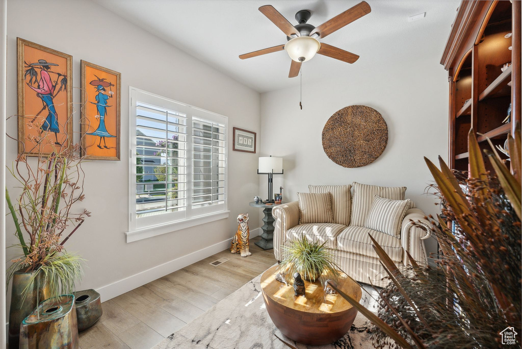 Living room featuring ceiling fan and light wood-type flooring