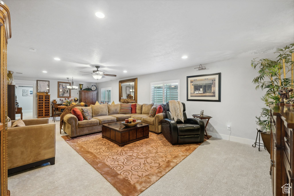 Carpeted living room with ceiling fan