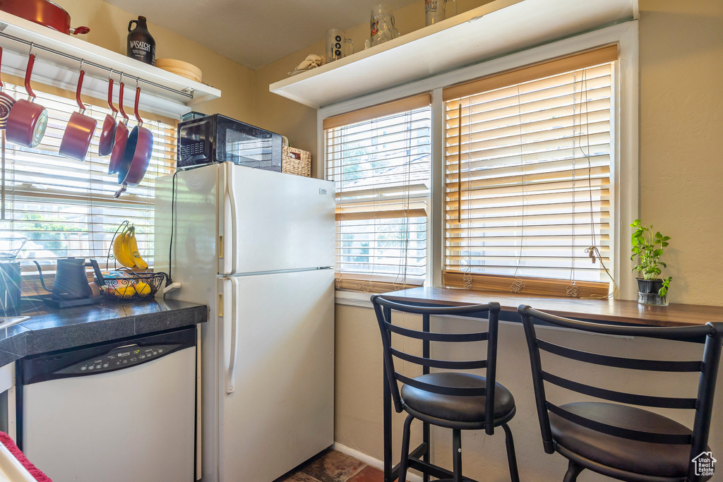 Kitchen with white fridge and dishwashing machine