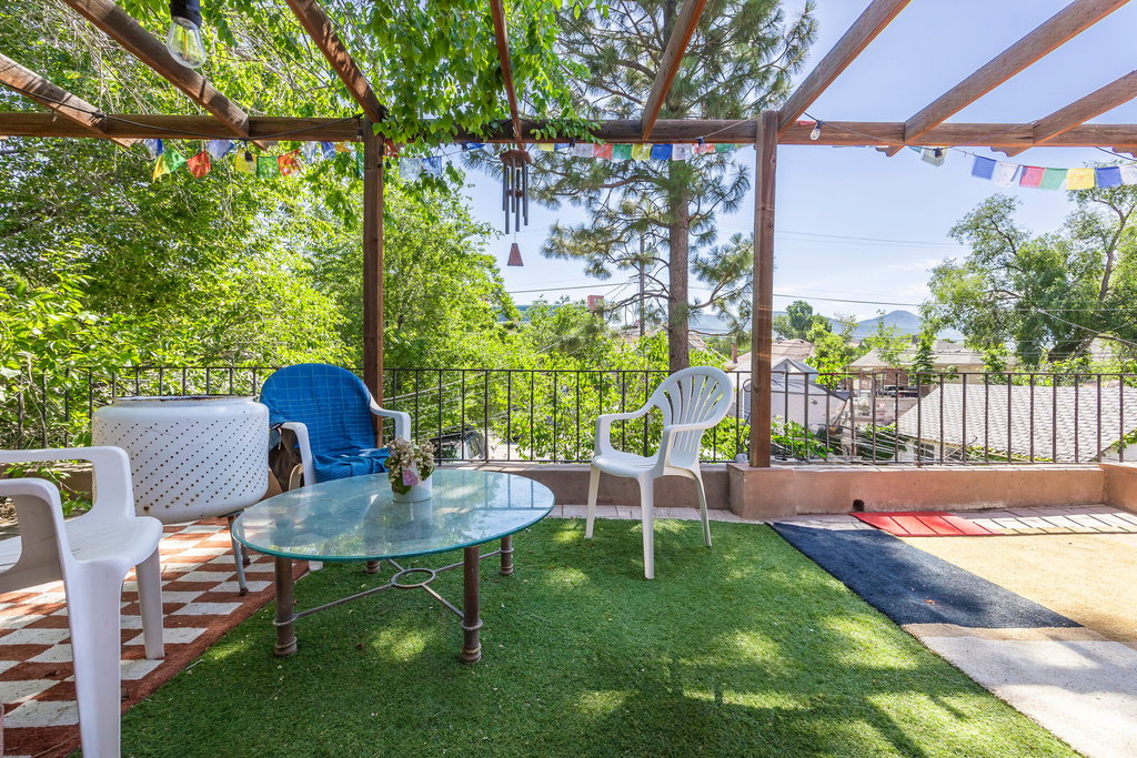 View of yard with a pergola and a patio