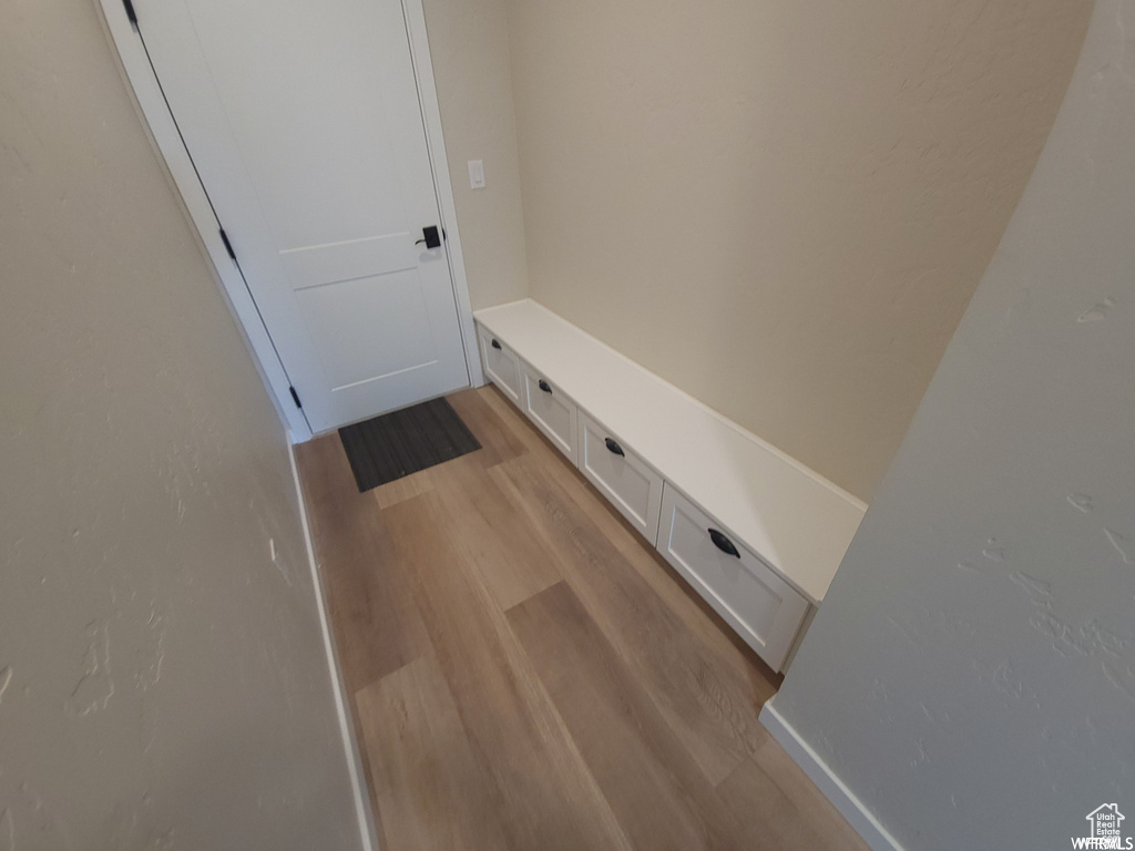 Mudroom with light hardwood / wood-style floors