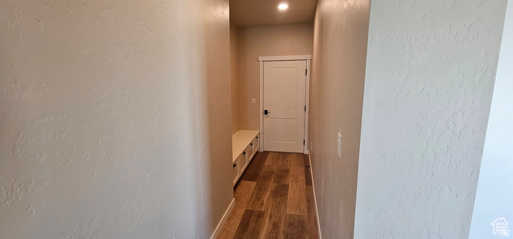 Hallway with dark wood-type flooring