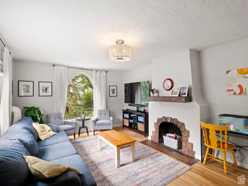 Living room with hardwood / wood-style flooring and a textured ceiling