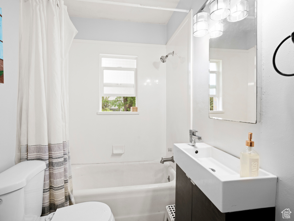 Full bathroom with shower / bath combo, vanity, and toilet