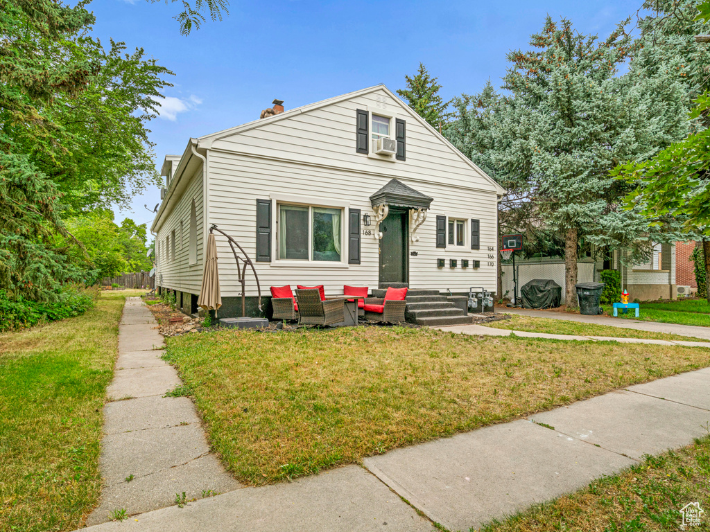 Bungalow-style house featuring a front lawn