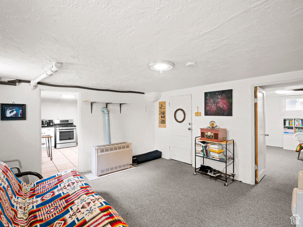 Living room with a textured ceiling and light tile floors