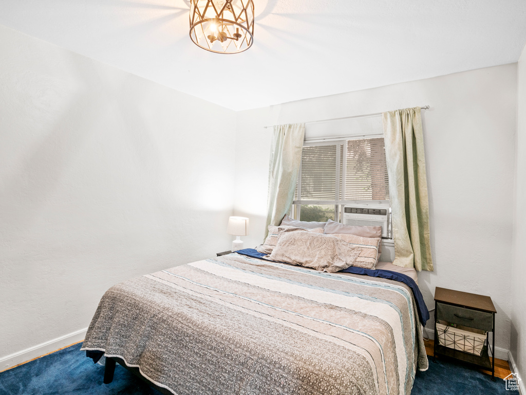 Carpeted bedroom with a chandelier