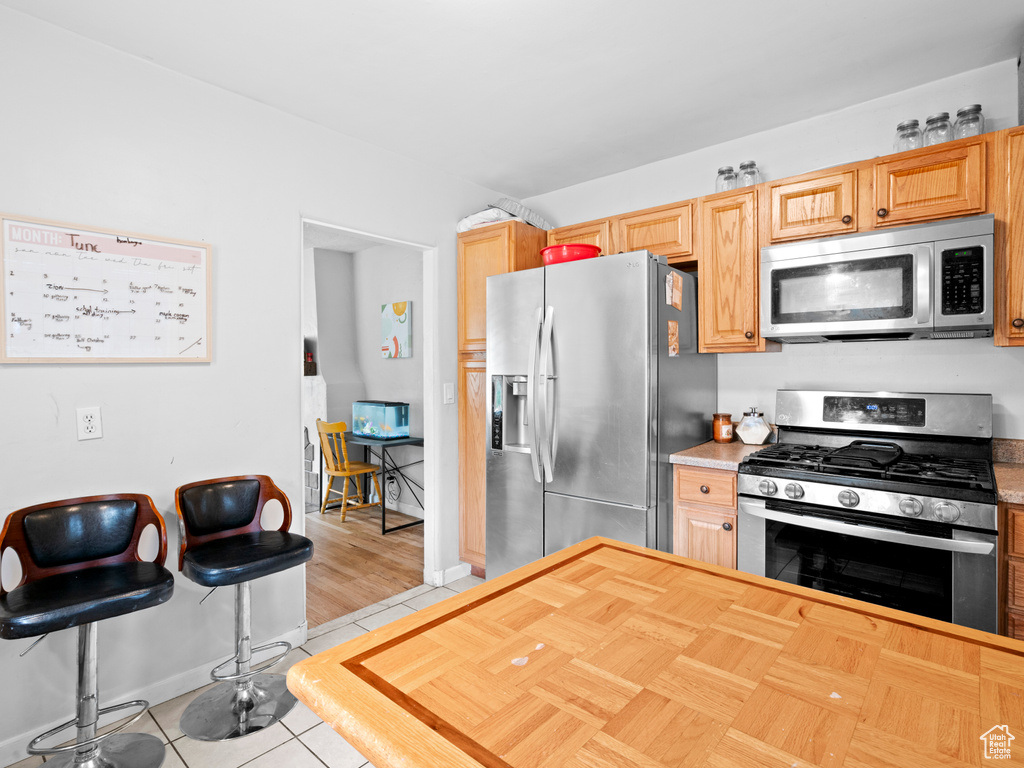 Kitchen featuring appliances with stainless steel finishes and light hardwood / wood-style flooring