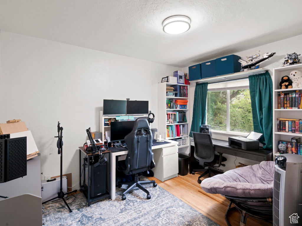 Home office with light hardwood / wood-style flooring